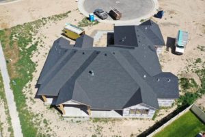 Aerial overview of a house with a completed roof during a construction project in Twin Falls, Idaho.
