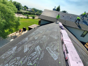 Technicians installing new roof shingles as a part of a reroofing project in Twin Falls, ID.