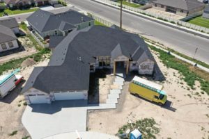 Aerial view from the front of a house with a newly completed roof during a roofing construction project in Twin Falls, ID.