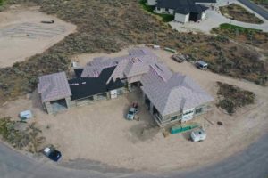 Alternate angle aerial overview of a house under construction with a roofing construction project underway in Twin Falls, ID.