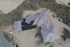 Aerial view of a house being constructed and having a new roof installed as a part of a roofing construction project in Twin Falls, ID.
