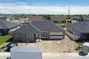 Front facing view of a house under construction with a completed new roof as a part of a roofing construction project in Twin Falls, Idaho.