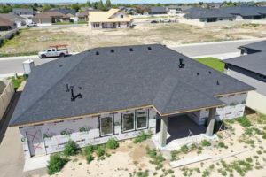 Aerial view from the back of a house under construction with a newly constructed roof as a part of a roofing construction project in Twin Falls, Idaho.