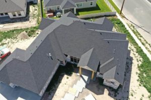 Alternate aerial overview of a house with a beautiful new roof as a part of a roof construction project in Twin Falls, Idaho.