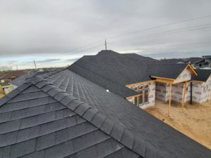 View of a house under construction with a completed roof during a construction project in Twin Falls, Idaho.